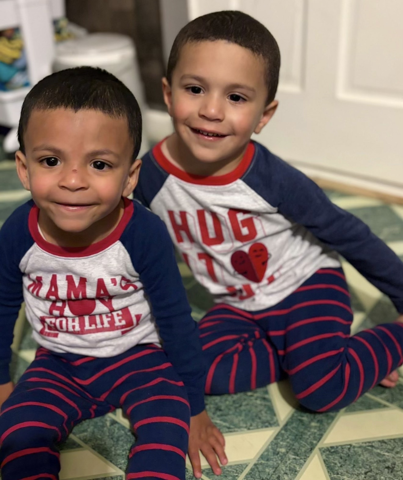 Jillian’s two young boys smiling together at home